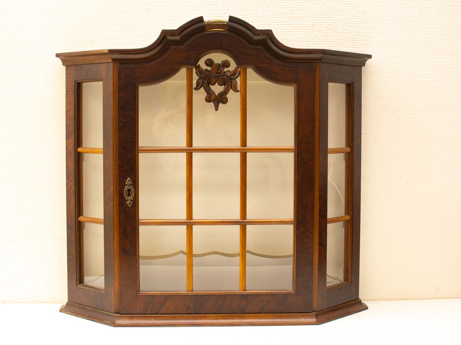 Timeless vintage wooden display cabinet with glass doors and intricate carvings, perfect for showcasing treasures.