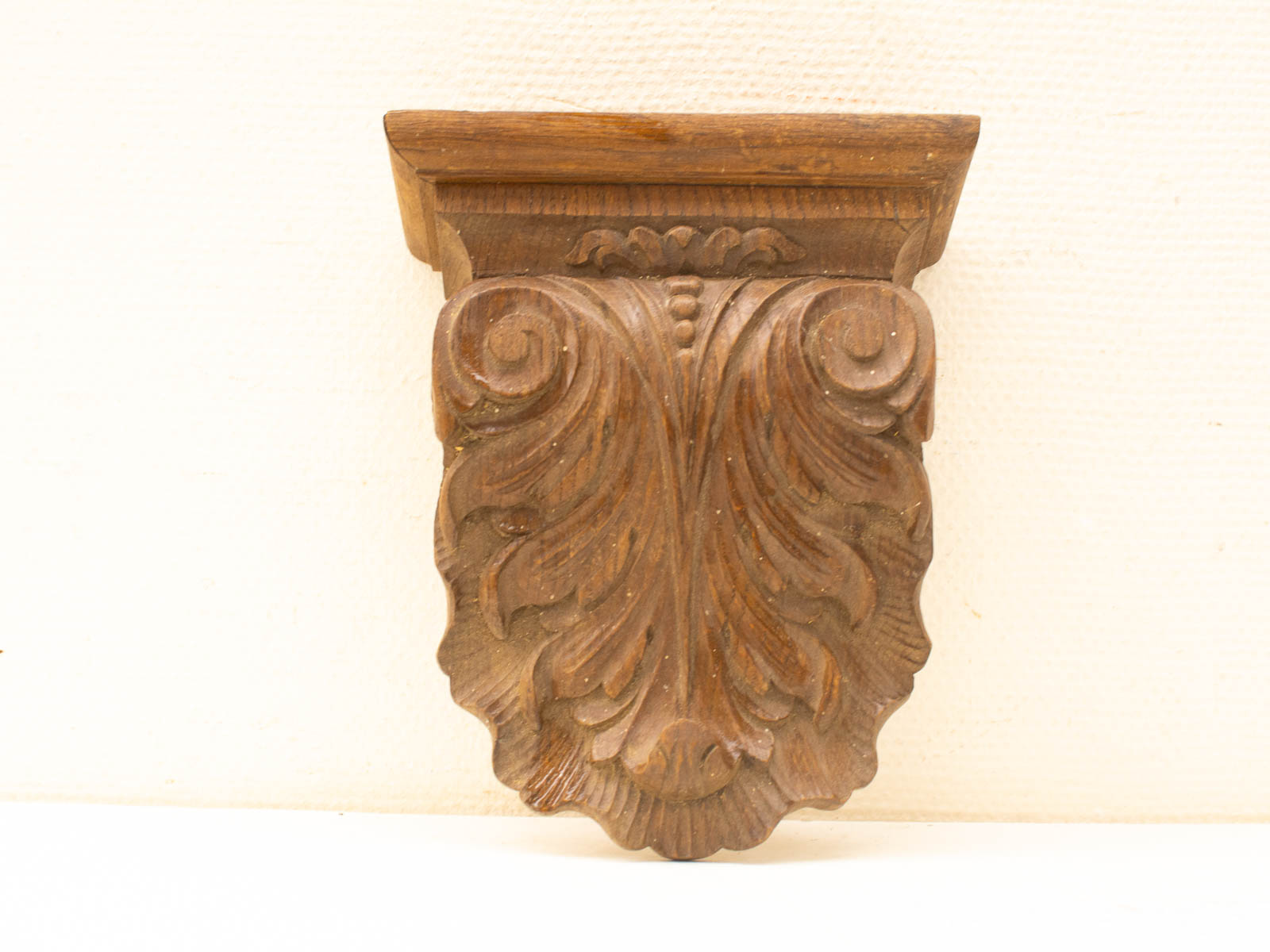 Intricate wooden wall ornament with scroll motifs, perfect for enhancing traditional decor.