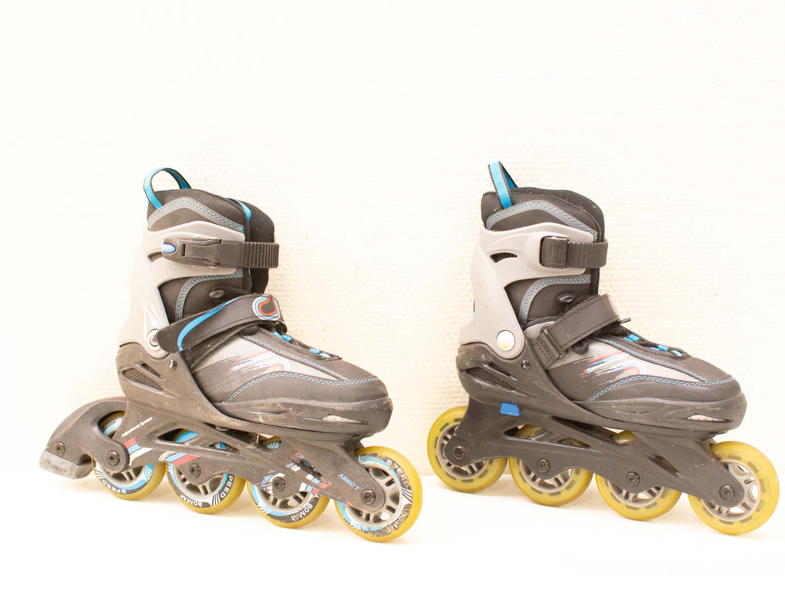 Sporty black inline skates with blue and yellow accents for stability and speed.