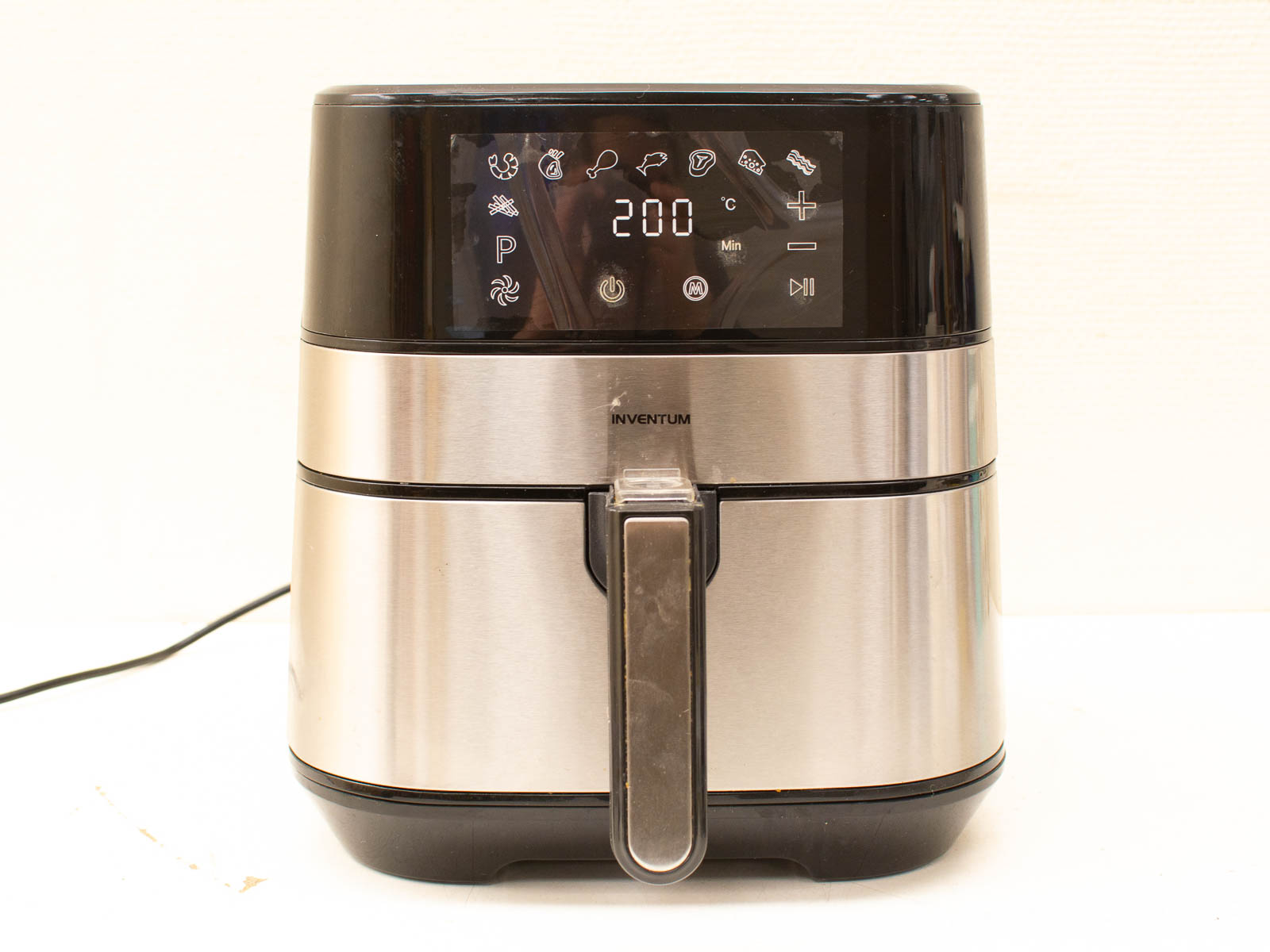 Sleek stainless steel air fryer with digital display for healthy, oil-free cooking convenience.