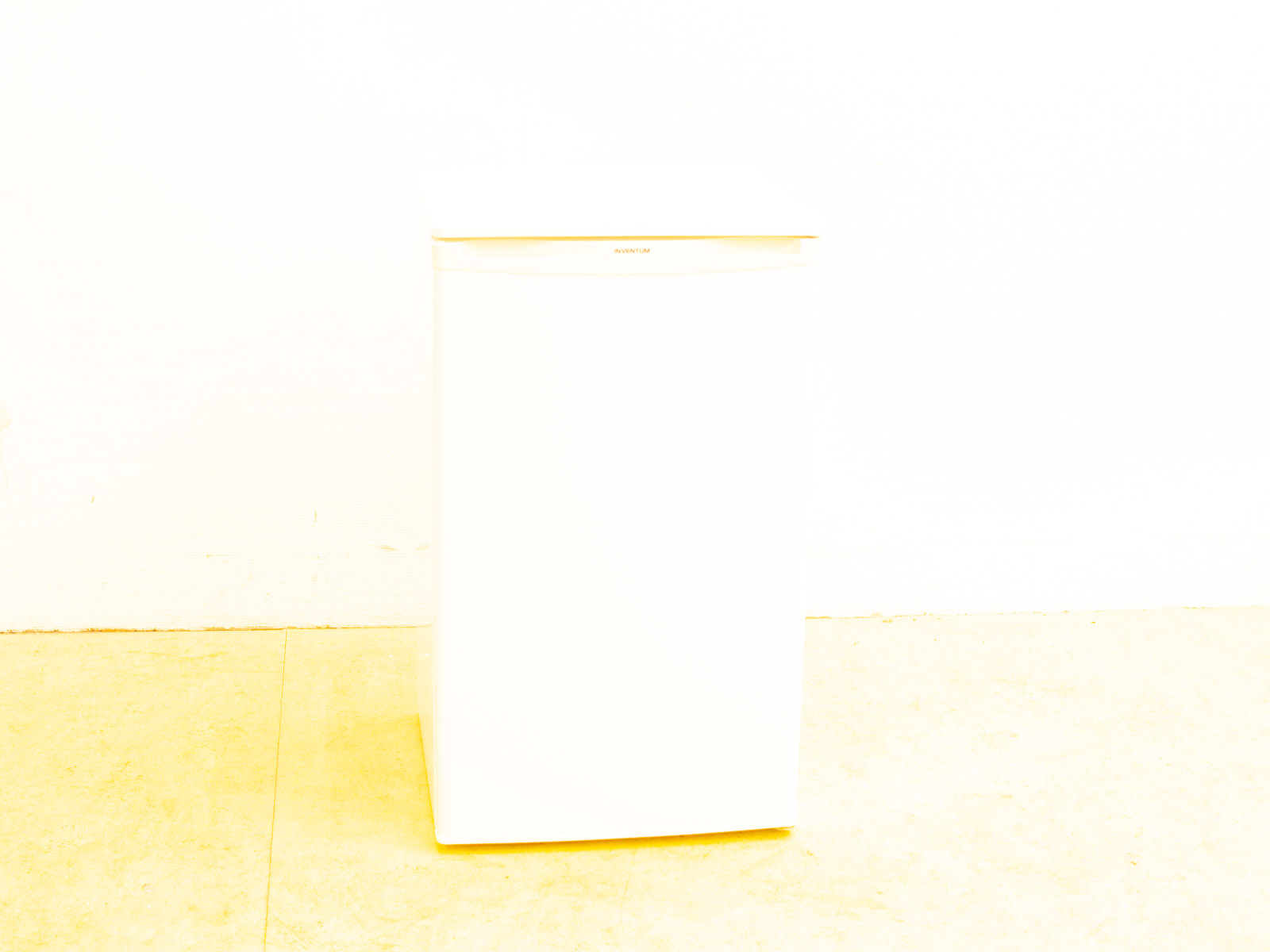 Sleek white mini refrigerator for small spaces, blending modern design with essential functionality.