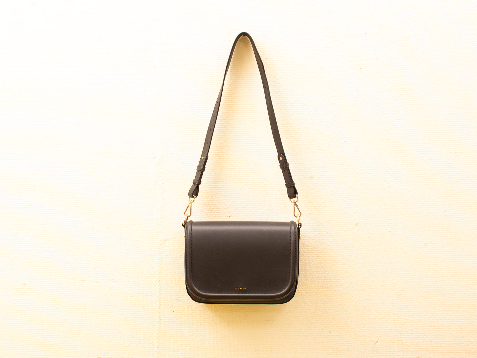 Elegant black leather handbag with adjustable strap, timeless design for versatile styling.