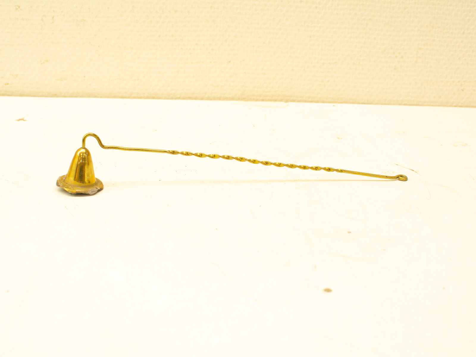 Elegant vintage brass bell with twisted handle, ideal for collectors and home decor.