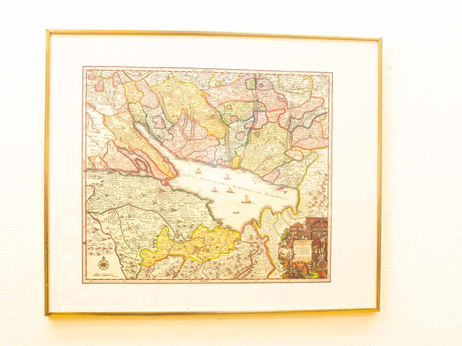 Antique Caspian Sea map: vibrant colors, detailed regions, and artistic illustrations in gold frame.