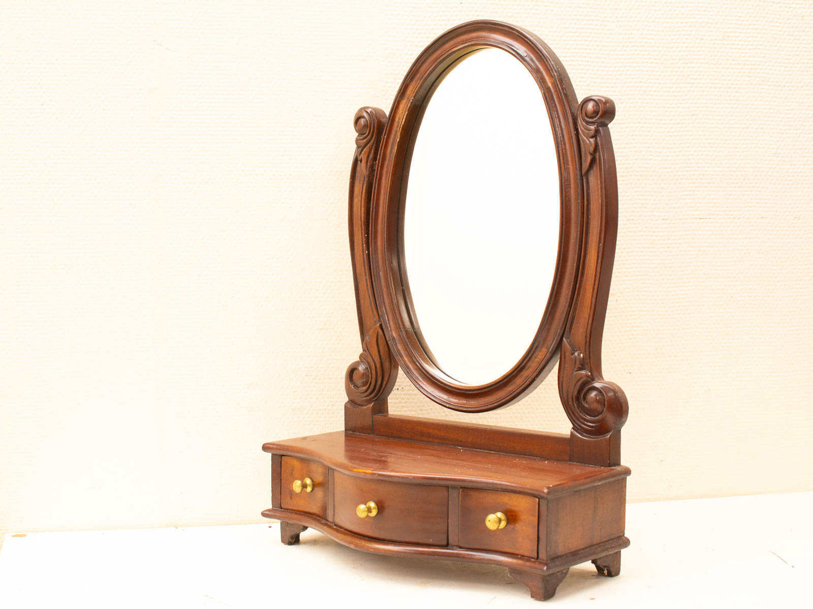 Elegant vintage wooden mirror and dresser set with intricate carvings and a polished finish.