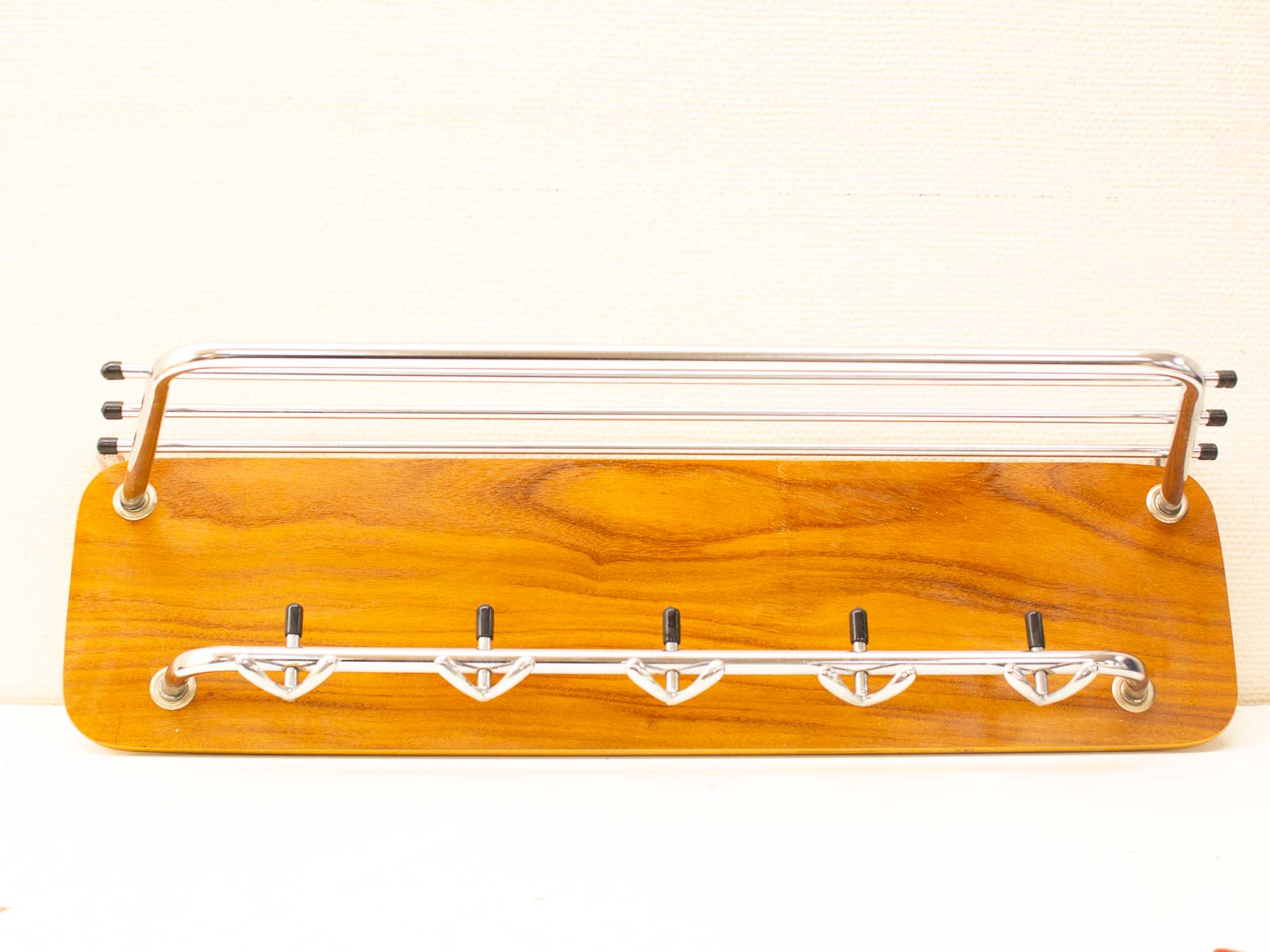 Sleek wood and stainless steel coat rack for stylish entryway organization.