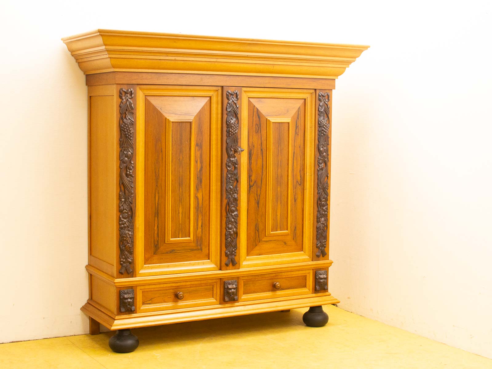 Elegant wooden cabinet with intricate carvings and modern feet, perfect for stylish storage and décor.