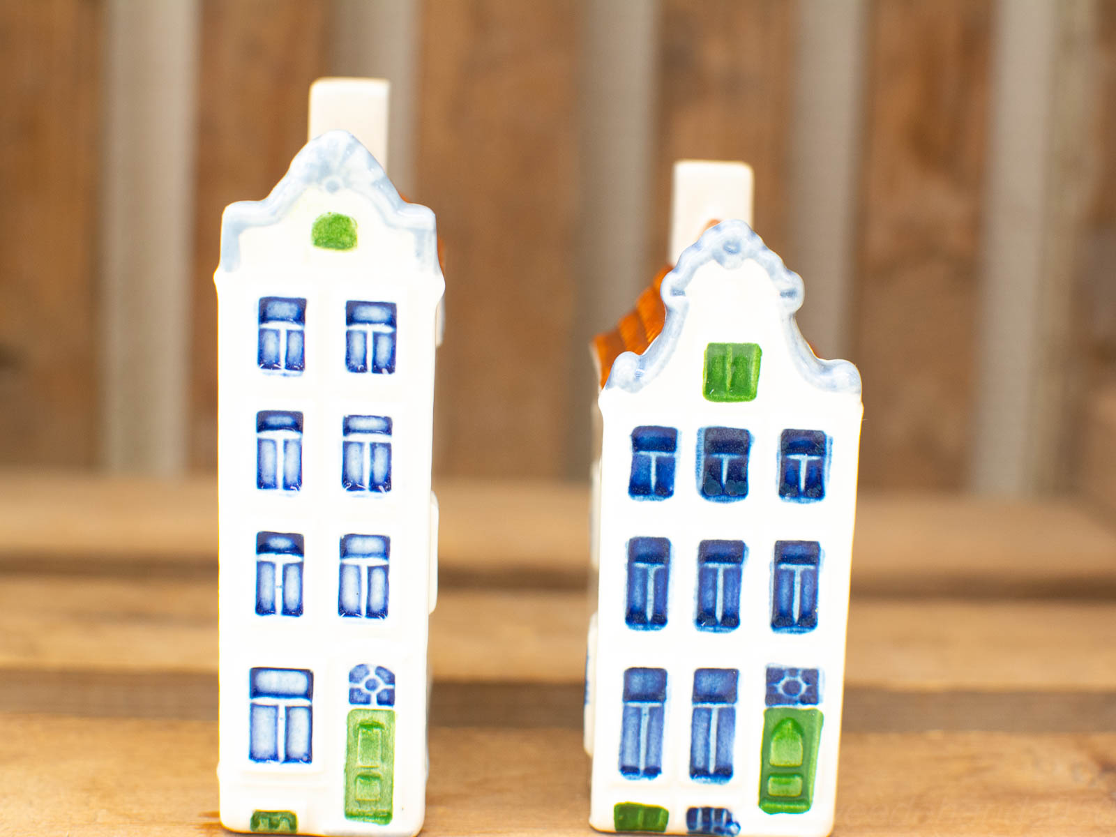 Charming vintage Delft-style ceramic houses with vibrant details for whimsical home decor.