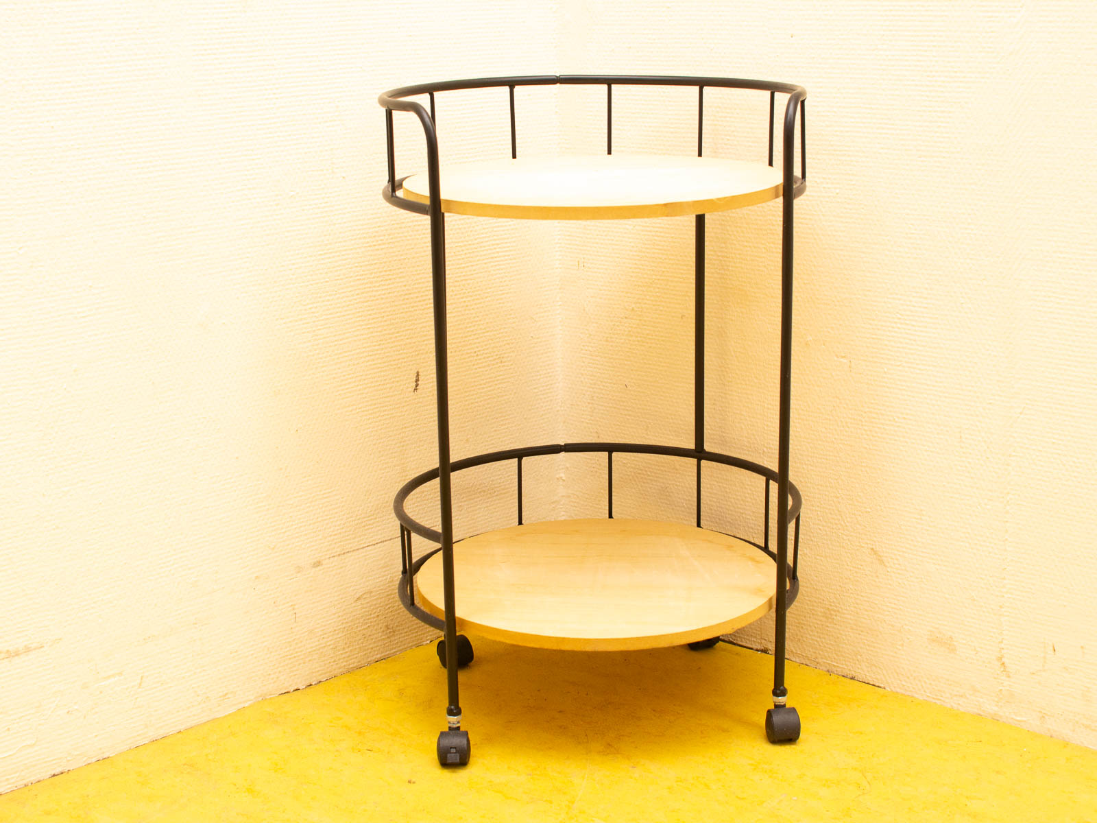 Stylish two-tiered cart with black metal frame and natural wood shelves, perfect for modern interiors.