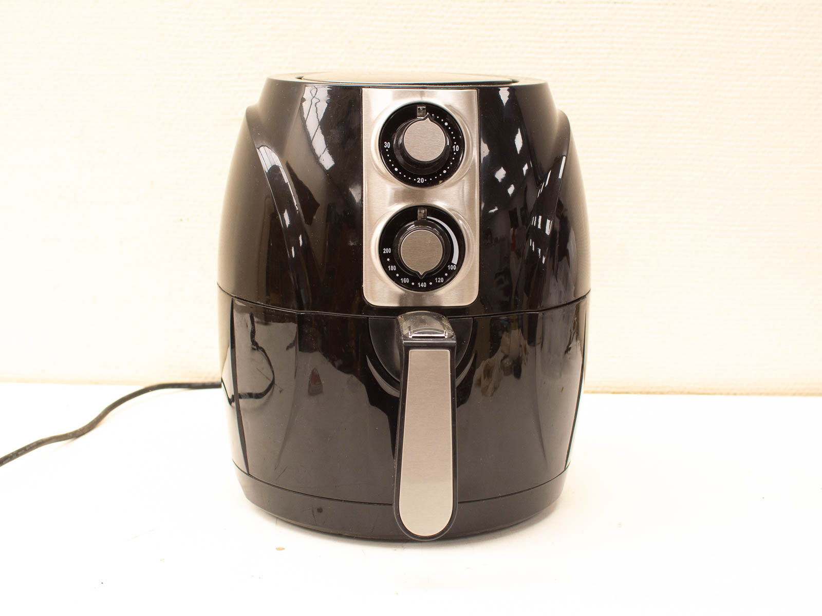 Sleek black air fryer for healthy cooking with user-friendly dials and compact design.