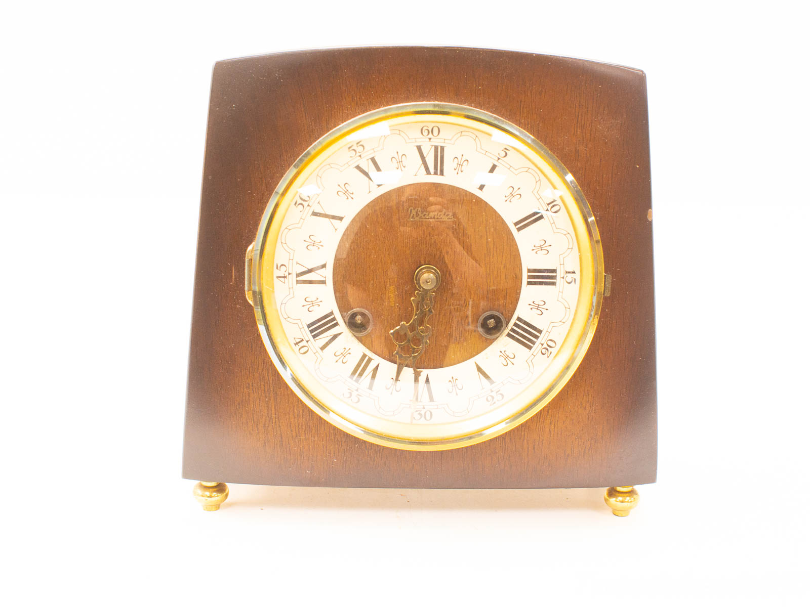 Elegant vintage wall clock with cream face, Roman numerals, and gold accents in dark wood.