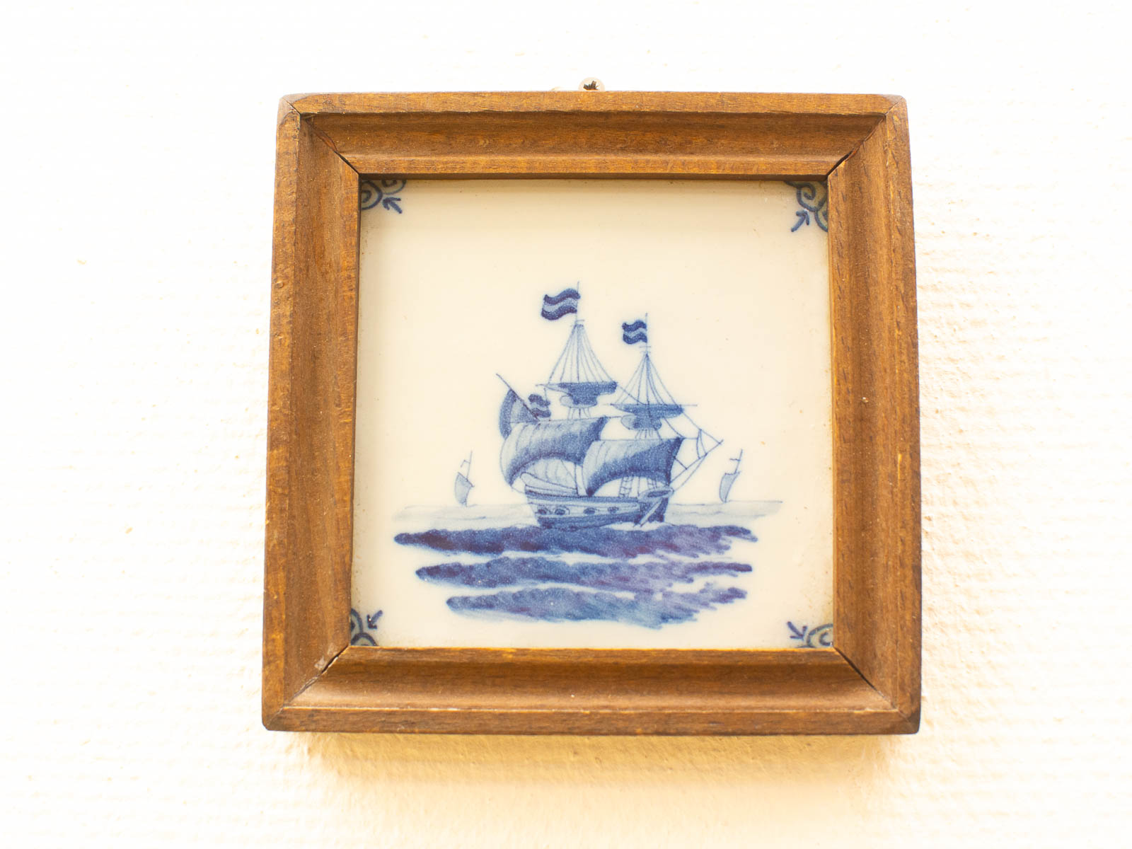 Classic sailing ship artwork in blue, elegantly framed, perfect for nautical decor.