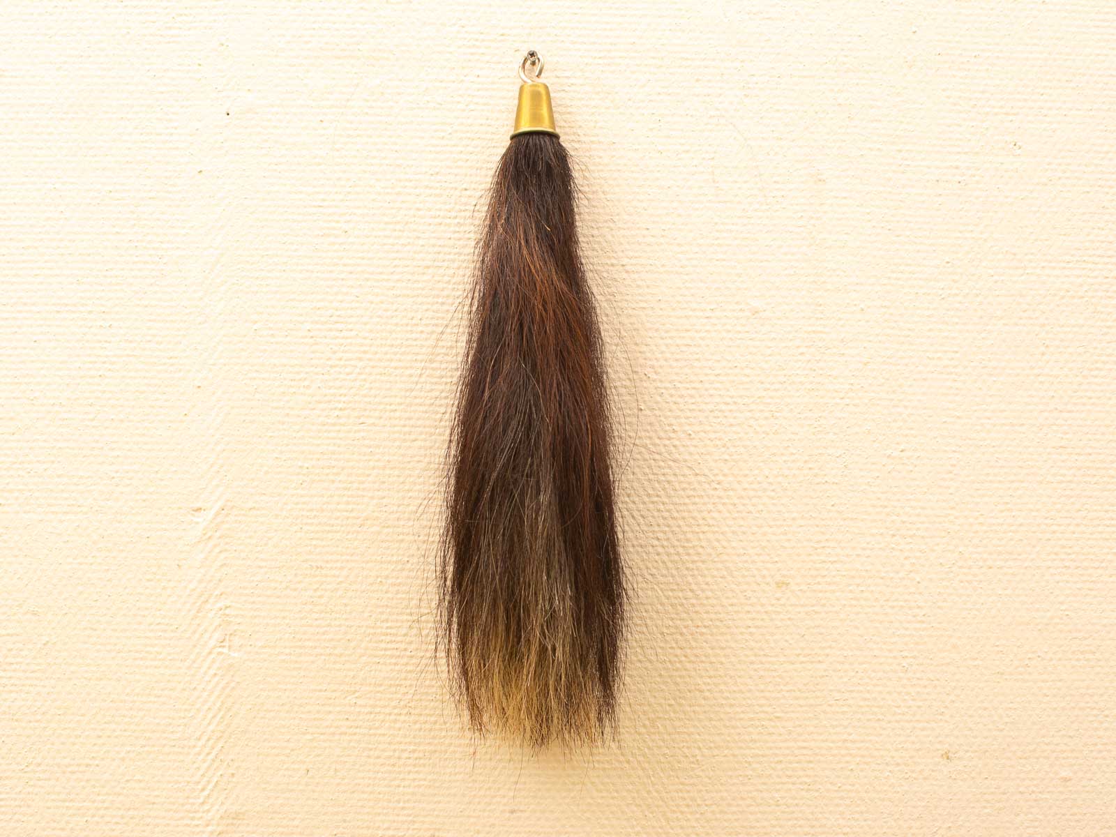 Elegant hair tuft with gold hanger, featuring a stunning brown to blonde ombre gradient.