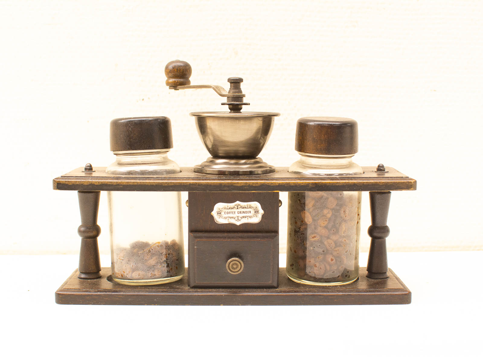 Elegant vintage coffee grinder with glass jars for beans and grounds, perfect for coffee lovers.