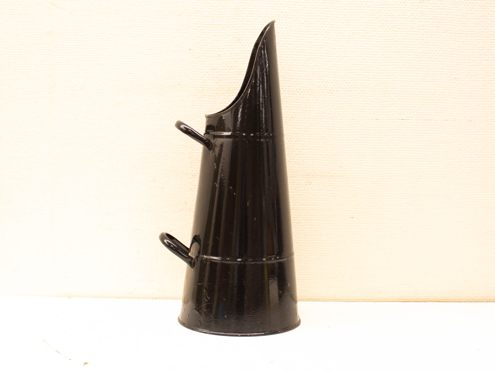 Elegant vintage black watering can, perfect for gardening or as a decorative home accent.