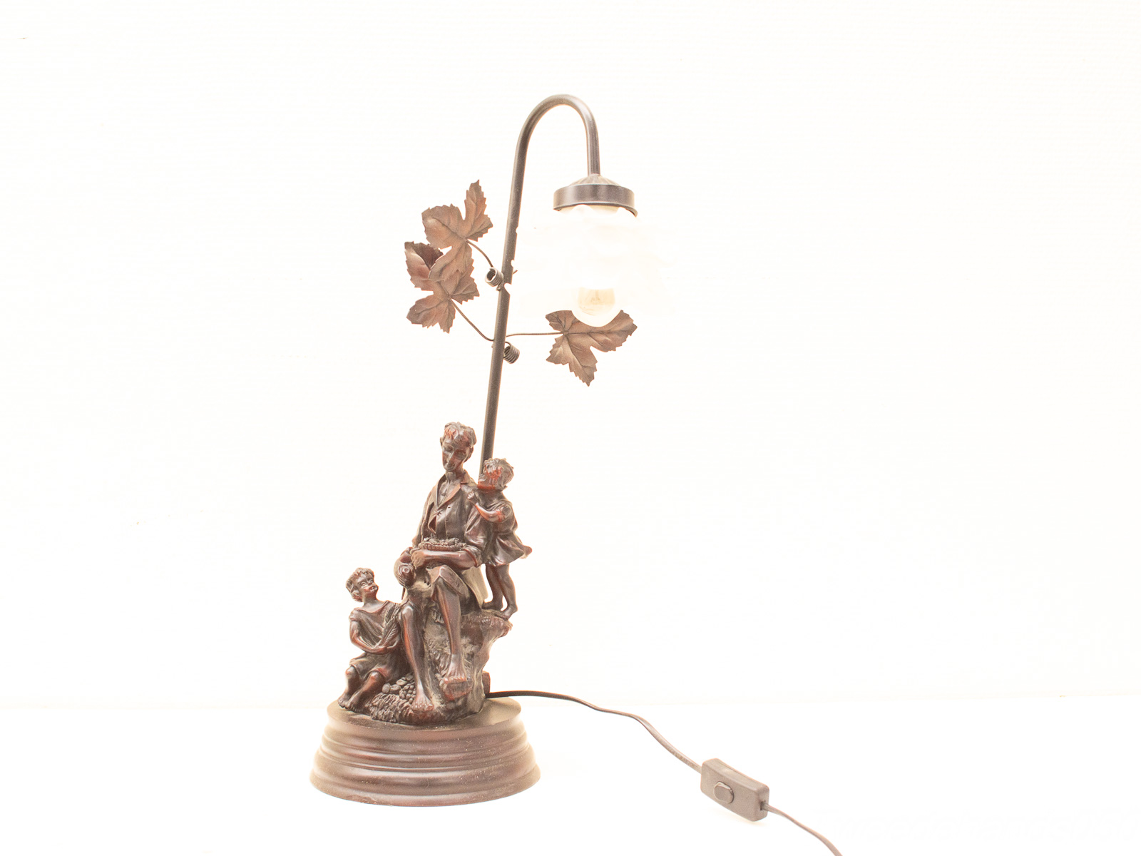 Vintage family lamp with bronze sculpture and frosted glass shade, perfect for warm lighting.