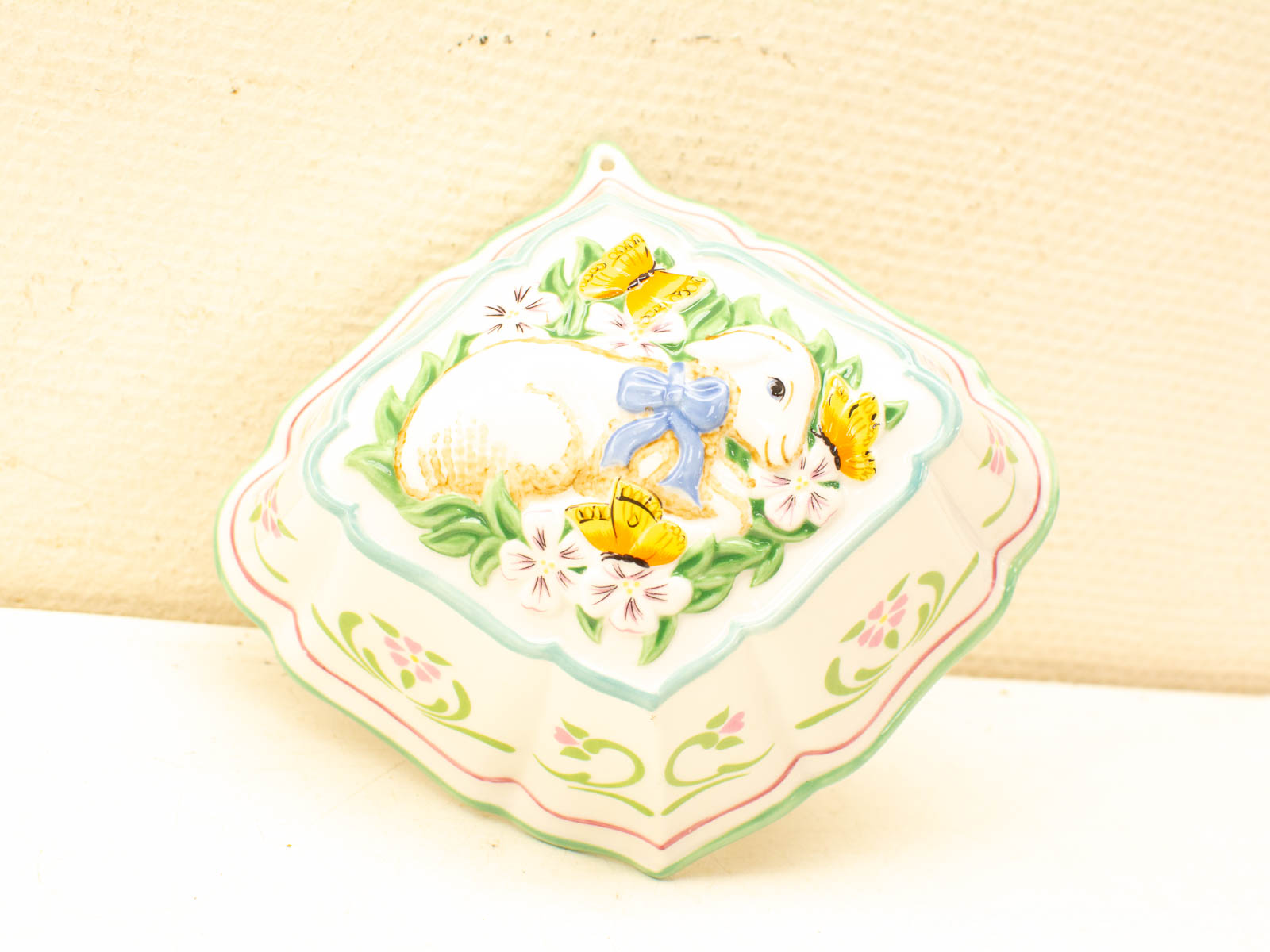 Whimsical decorative box with a bunny, flowers, and butterflies in pastel colors. Perfect gift!