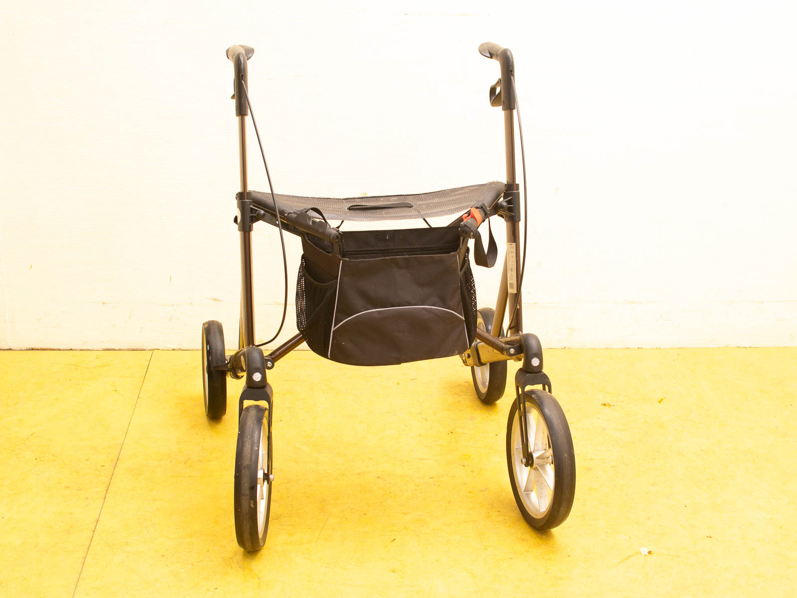 Lightweight walker with seat and storage, offering comfort and stability for enhanced mobility.