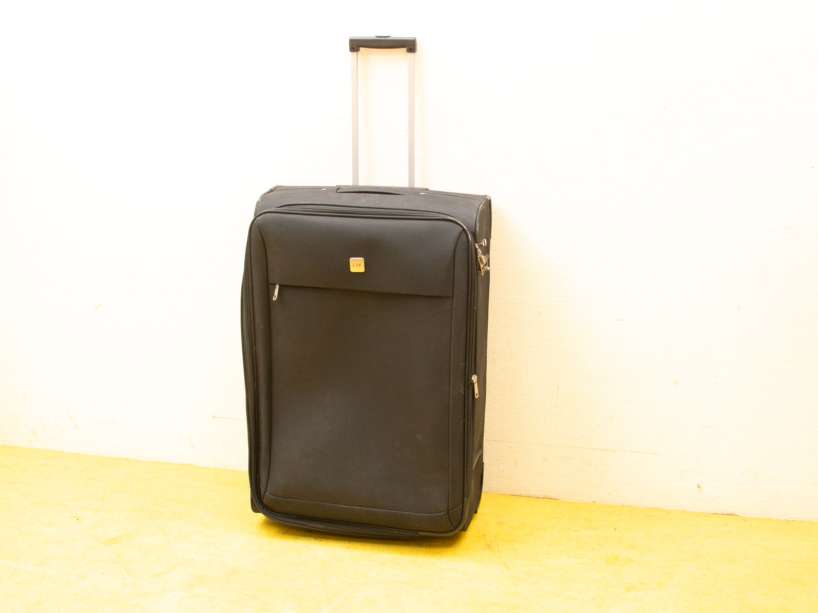 Sleek black suitcase with a minimalist design, perfect for stylish and practical travel.