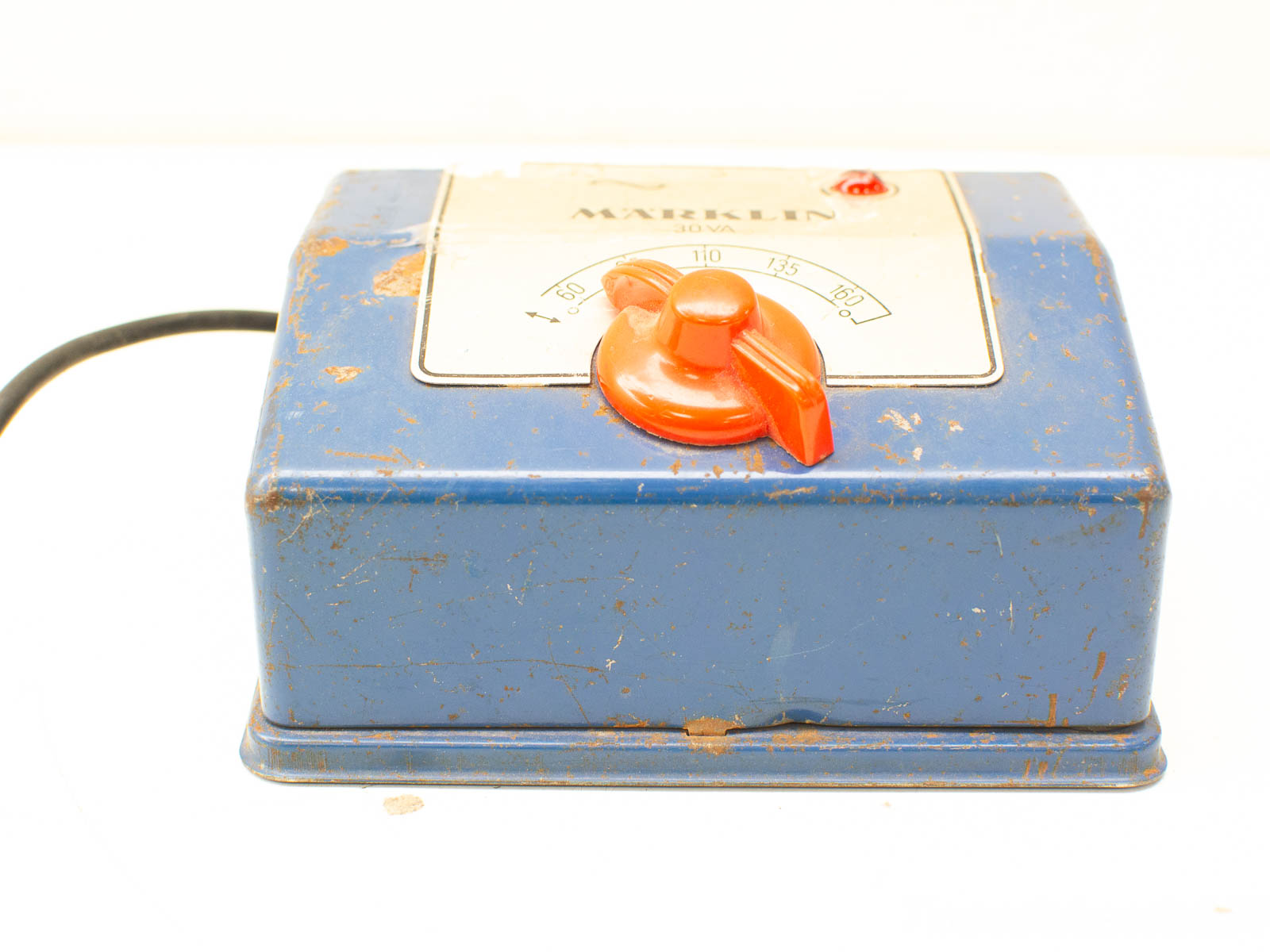 Worn blue Mazeklin transformer with orange knob and red light, perfect for vintage enthusiasts.