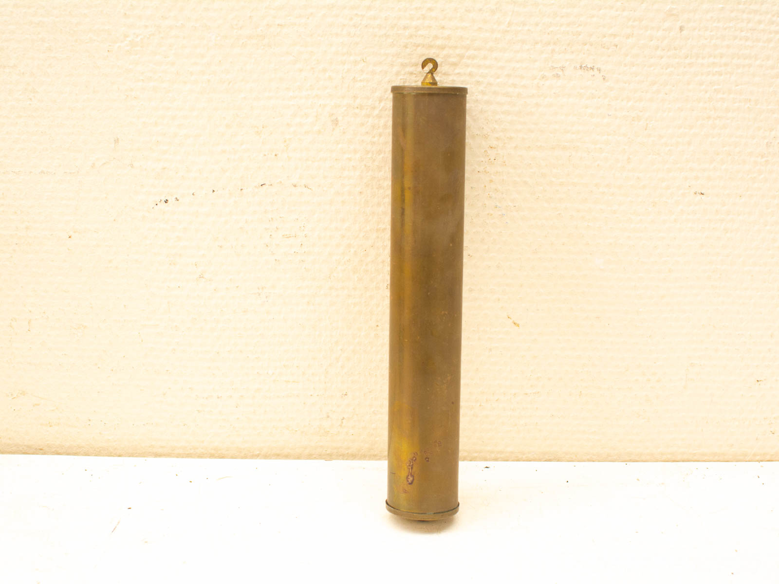 Sleek vintage brass cylinder with hook, ideal for functional use in workshops or outdoors.