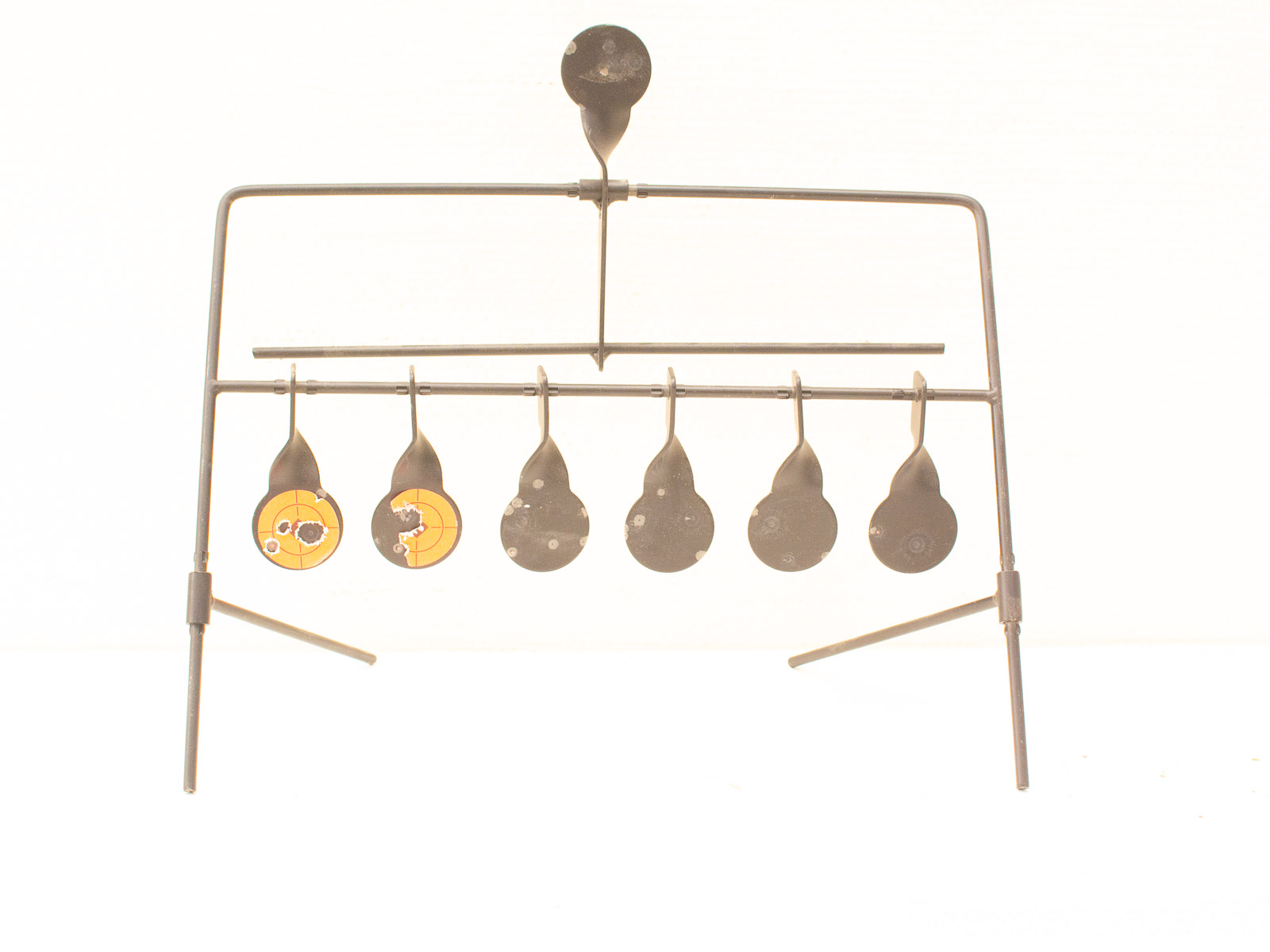 Colorful pendulum display stand for educational demonstrations on motion and energy principles.