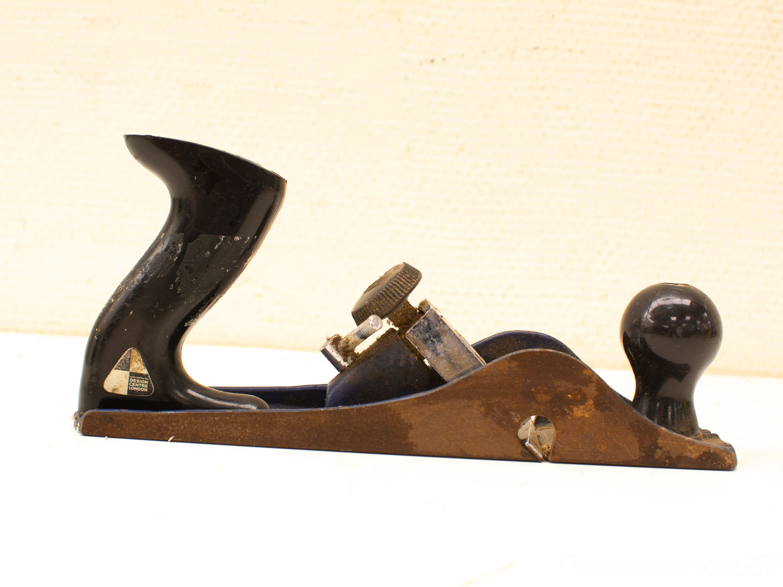 Vintage handplane with wooden handle, essential for woodworking and showcasing quality craftsmanship.