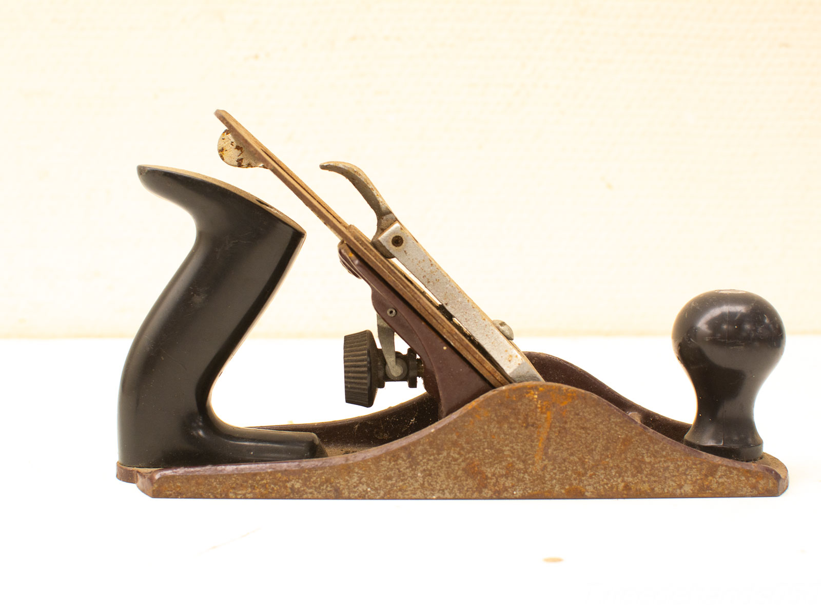 Vintage hand plane with rustic charm, durable metal, and expert craftsmanship for woodworking.