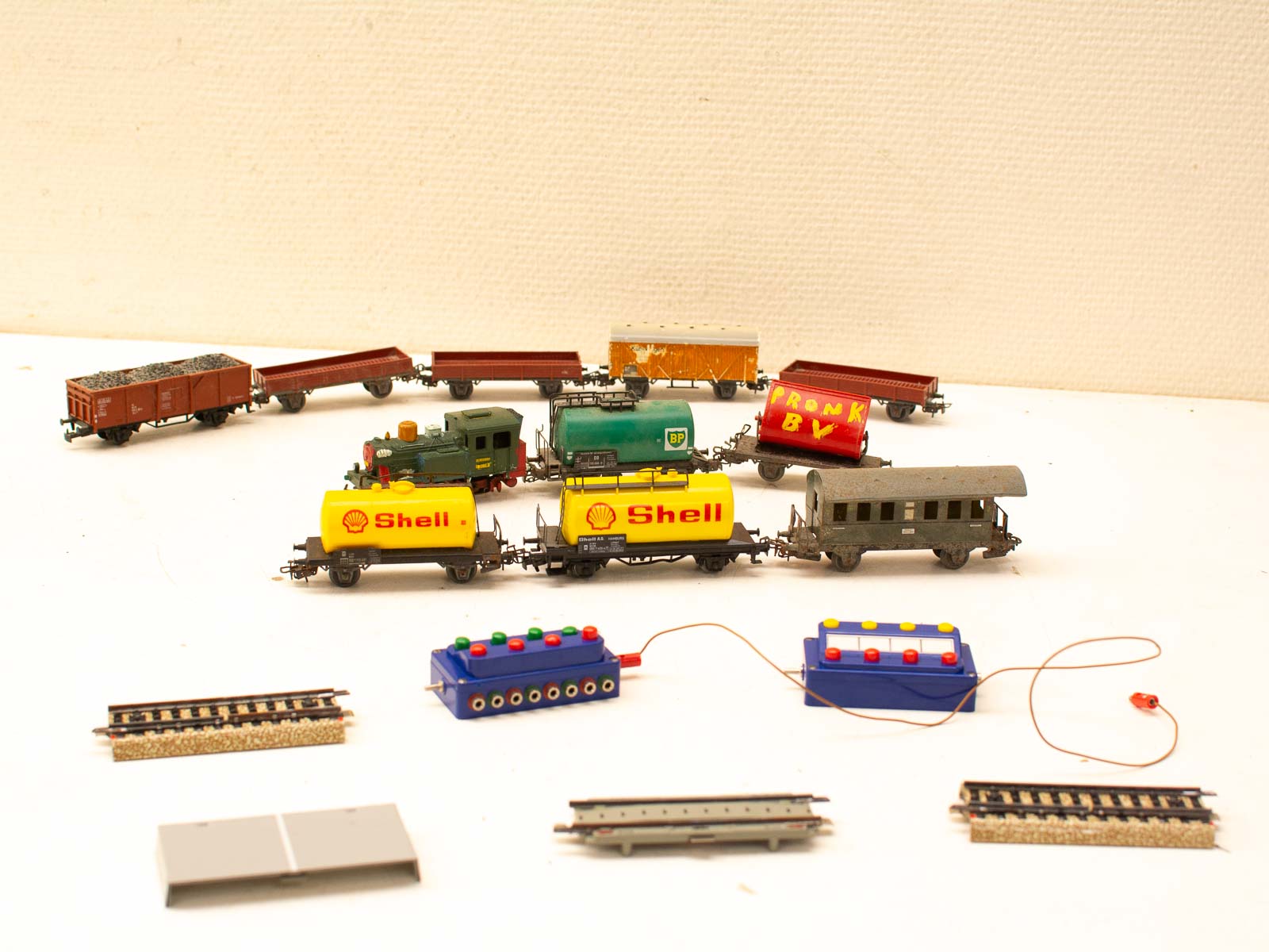 Charming vintage toy trains and tracks collection, featuring colorful cars and a nostalgic steam locomotive.