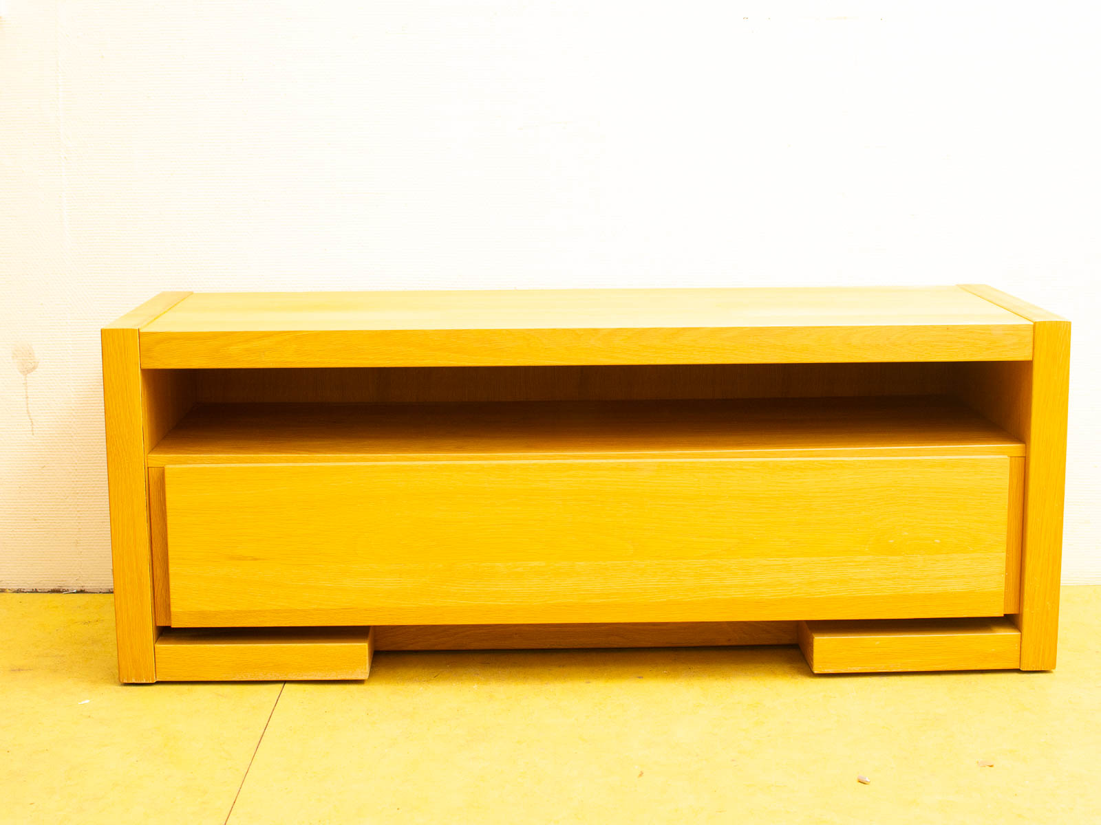 Modern minimalist wooden console with open shelf and drawer for stylish storage solutions.