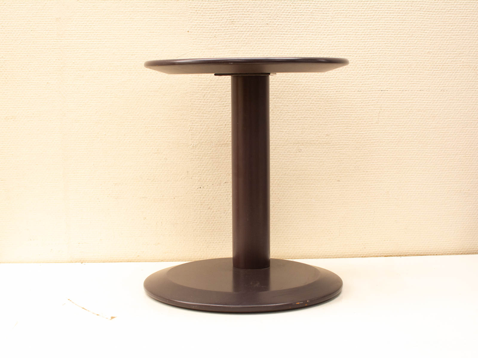 Sleek modern round table with polished dark finish, ideal for stylish living spaces and offices.