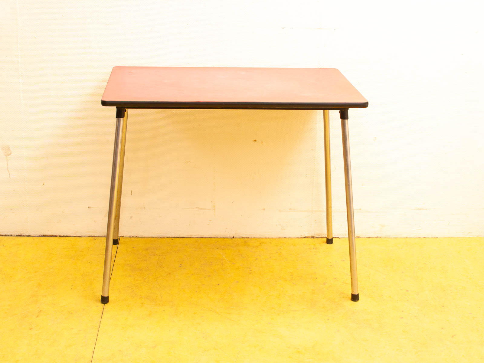 Sleek minimalist table with polished metal legs, perfect for modern workspaces and creative environments.