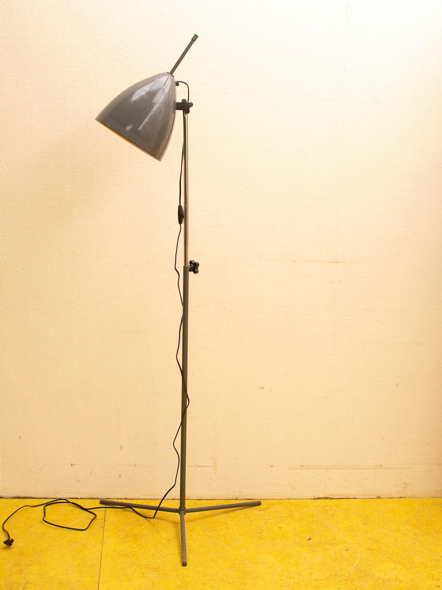 Sleek gray floor lamp with conical shade and tripod base for stylish illumination.