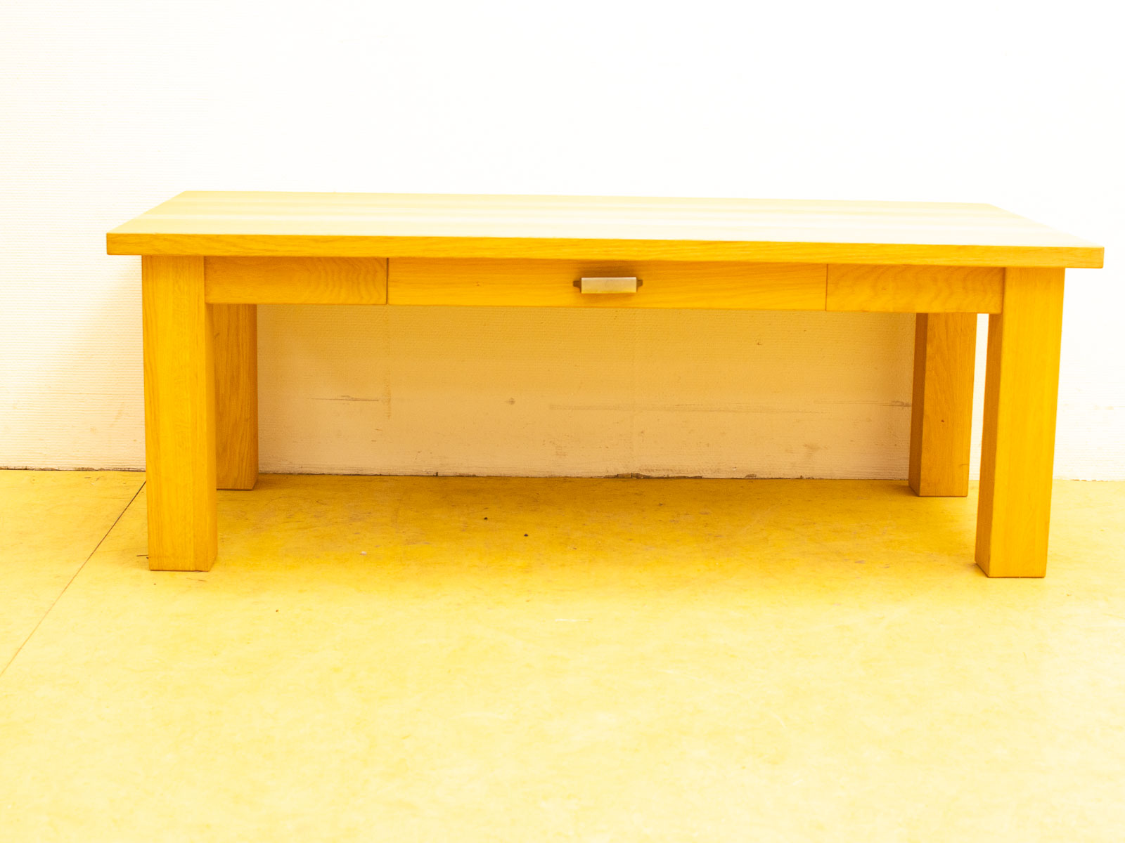 Modern light wood table with drawer, perfect for minimalist decor and versatile storage solutions.