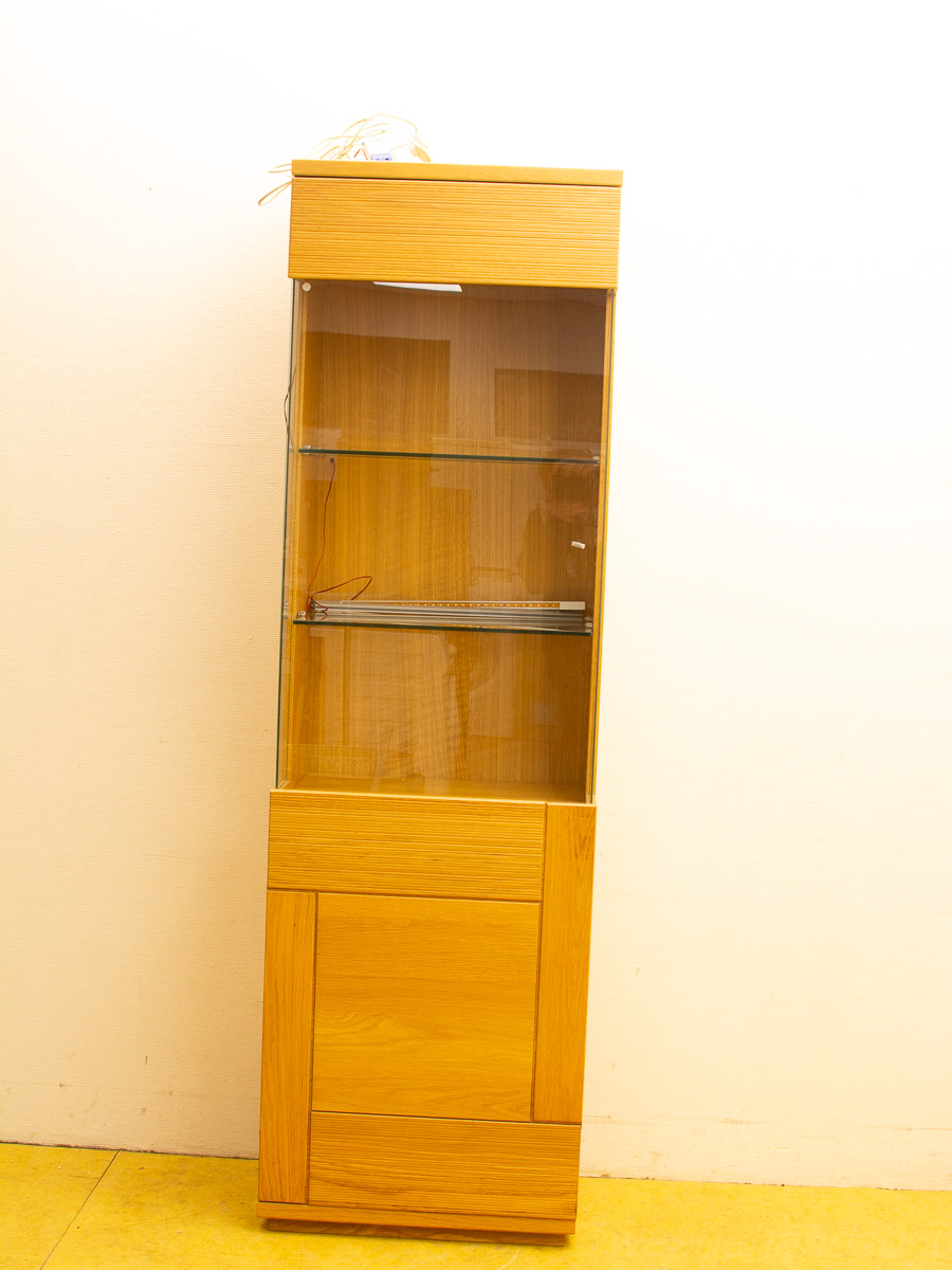 Modern light wood display cabinet with glass doors and adjustable shelves, perfect for showcasing decor.