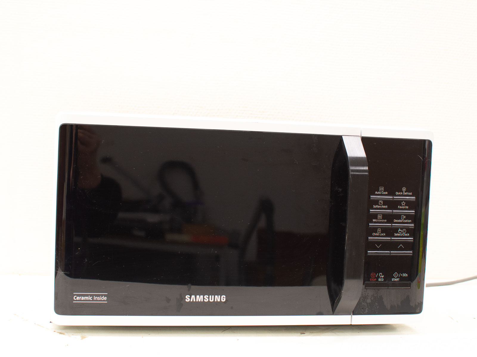 Modern black microwave with Ceramic Inside for easy cleaning and user-friendly controls.