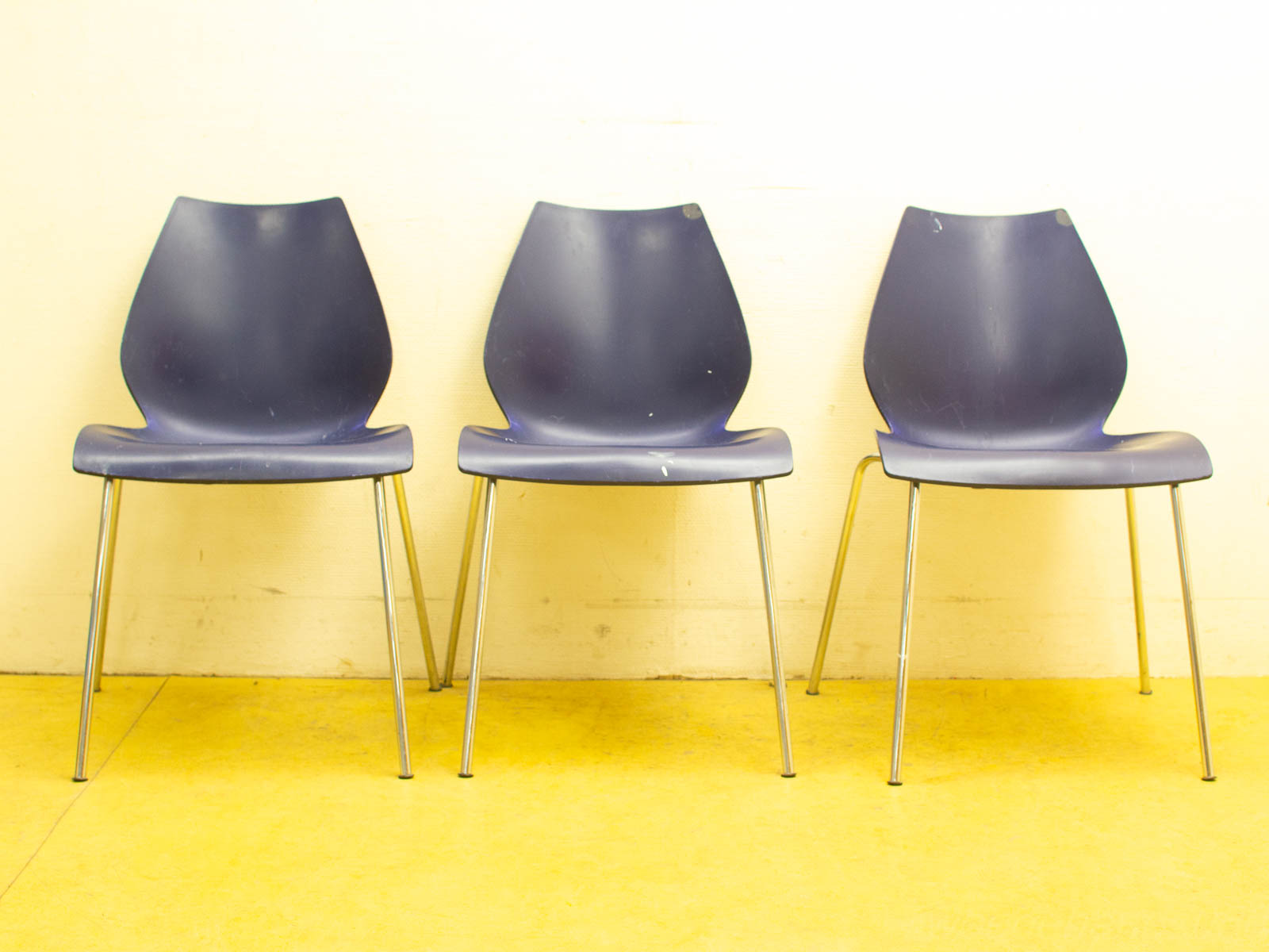 Chic navy blue chairs with chrome legs for modern, stylish living or office spaces.