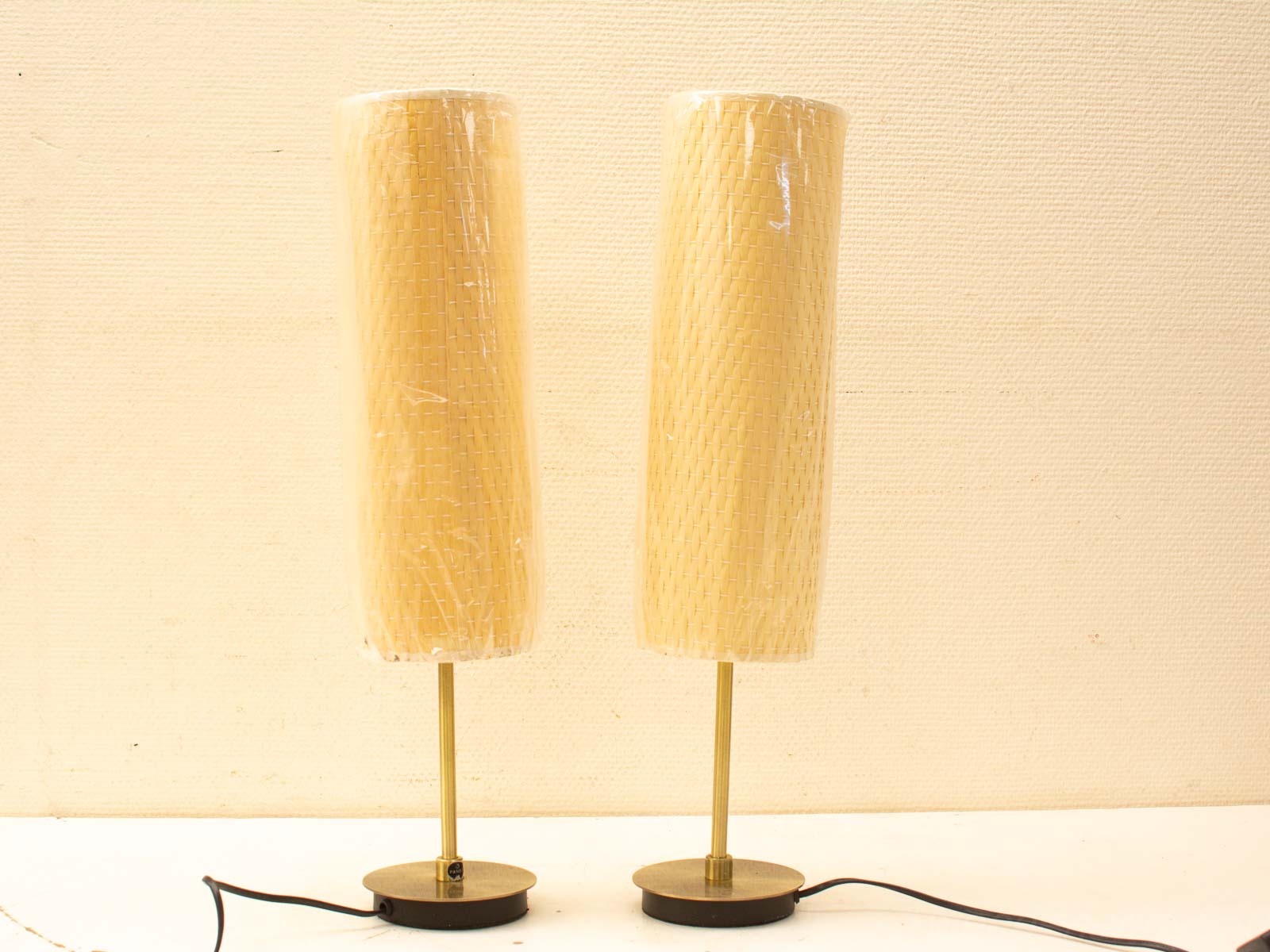 Stylish modern table lamps with woven shades and brass bases, perfect for any interior.