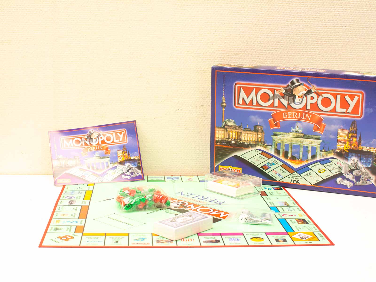 Discover Berlin through this vintage Monopoly game featuring iconic landmarks and colorful properties.