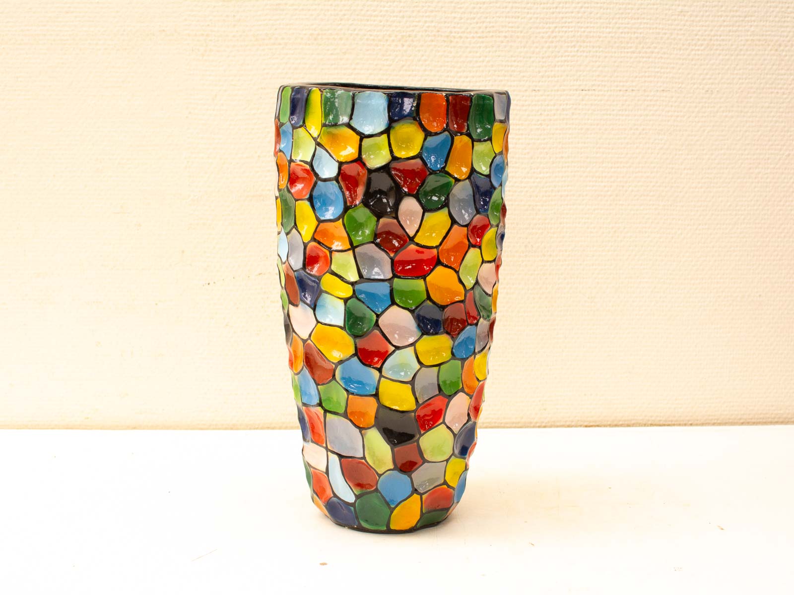 Vibrant mosaic vase with colorful tiles, perfect for decor or floral arrangements.