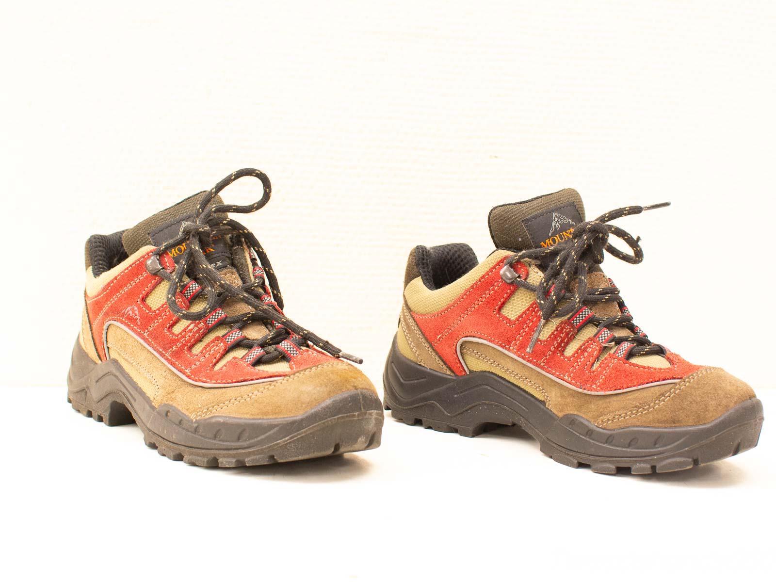 Stylish red hiking shoes with durable suede, designed for traction and comfort on outdoor adventures.