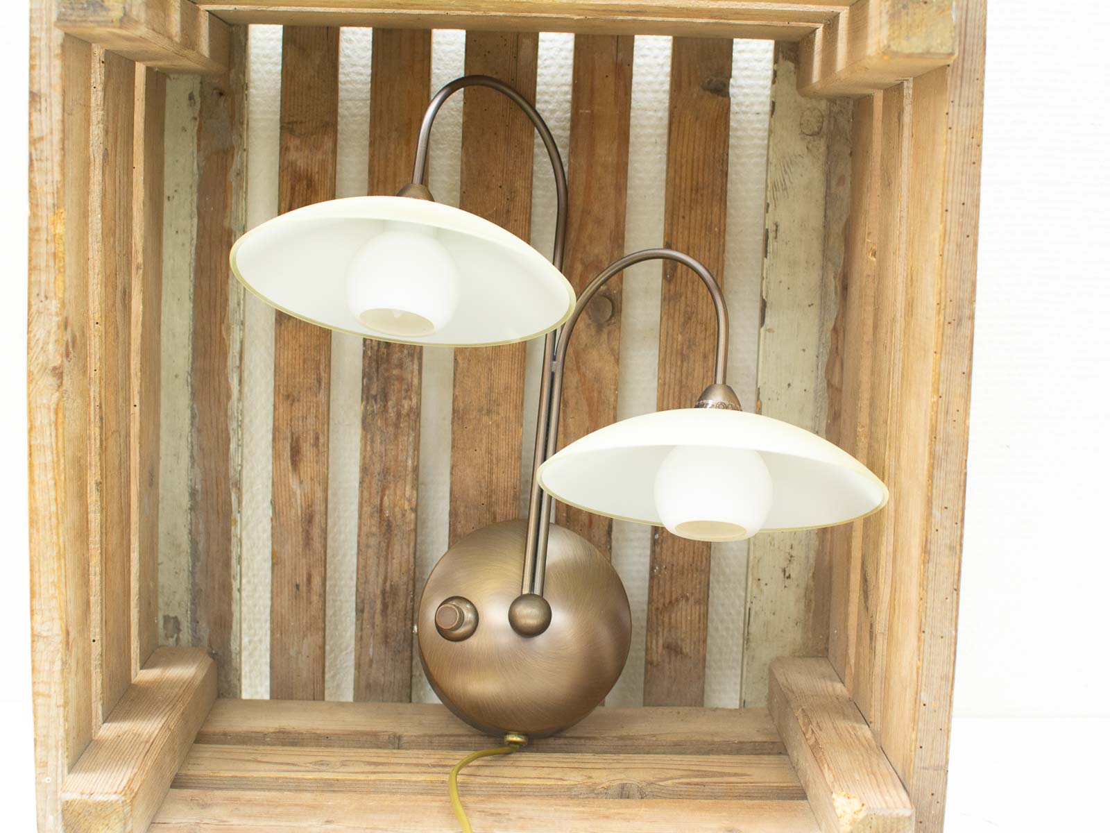 Stylish lamp in rustic crate, blending modern elegance with vintage charm for any space.