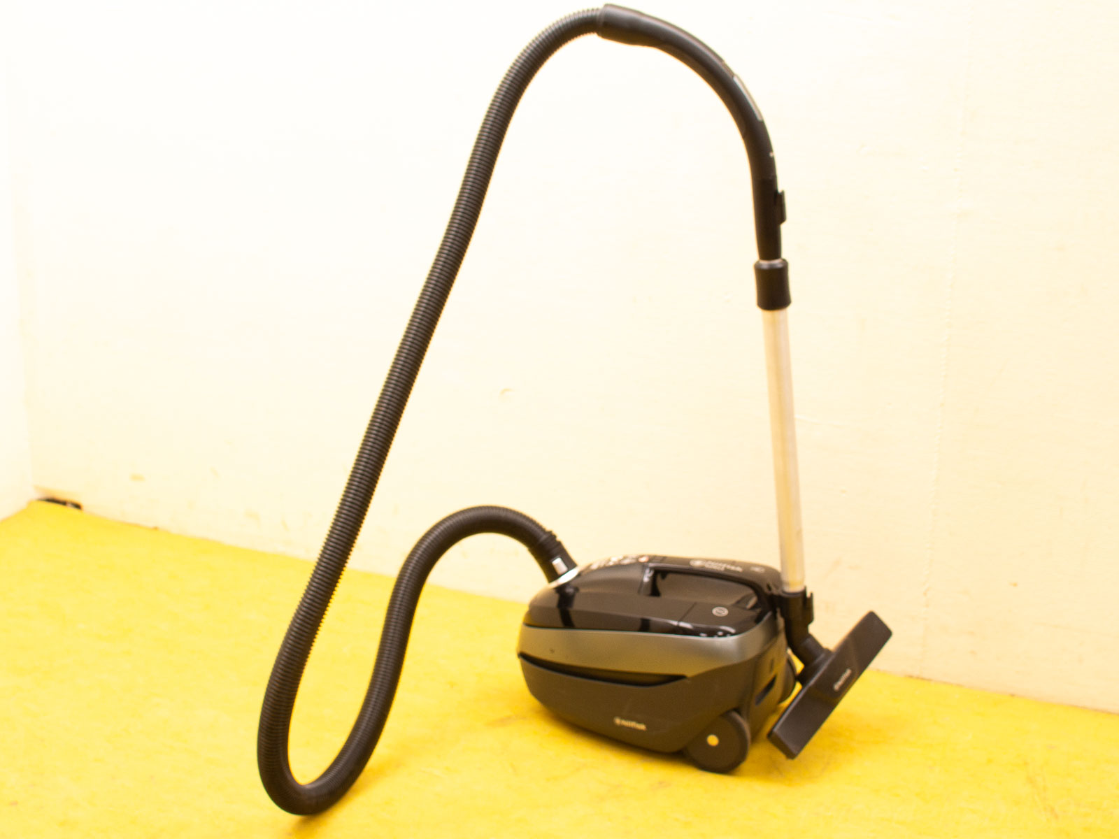 Sleek black compact canister vacuum for efficient cleaning in modern homes.