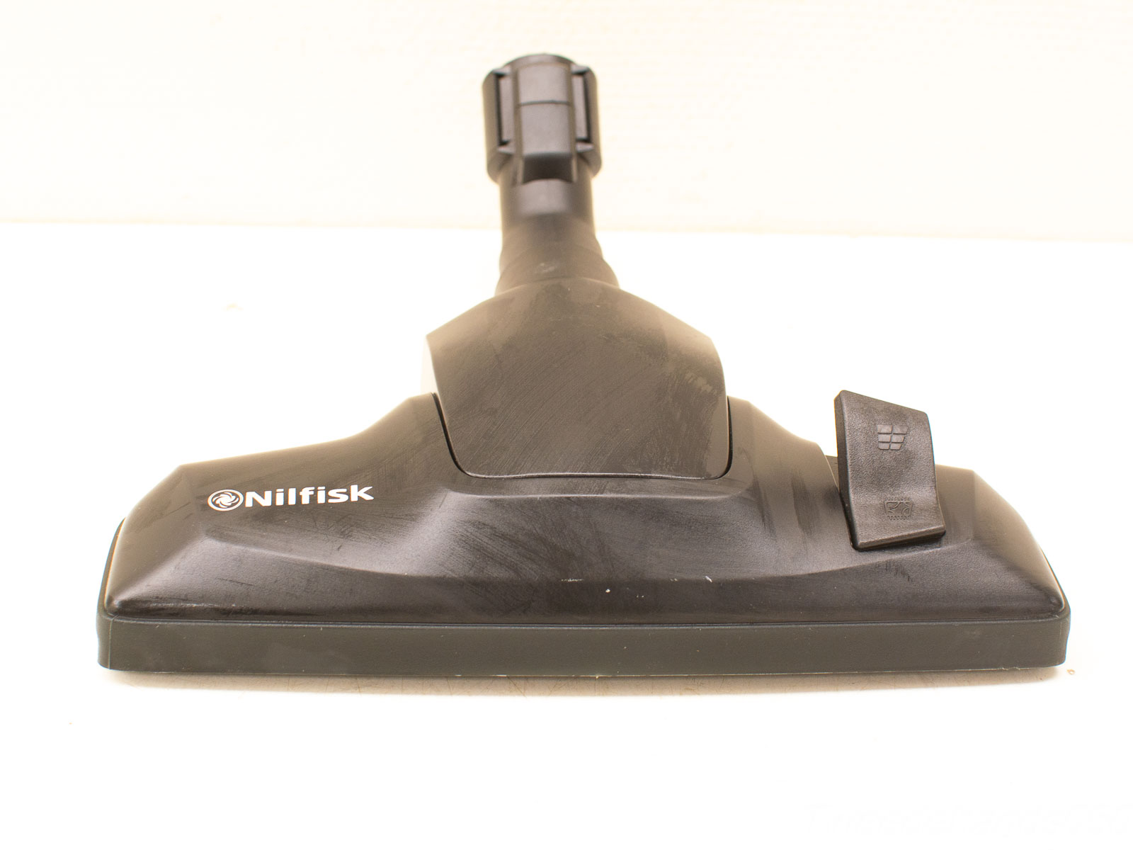 Nilfisk vacuum attachment with sleek matte black finish for efficient cleaning and easy maneuverability.