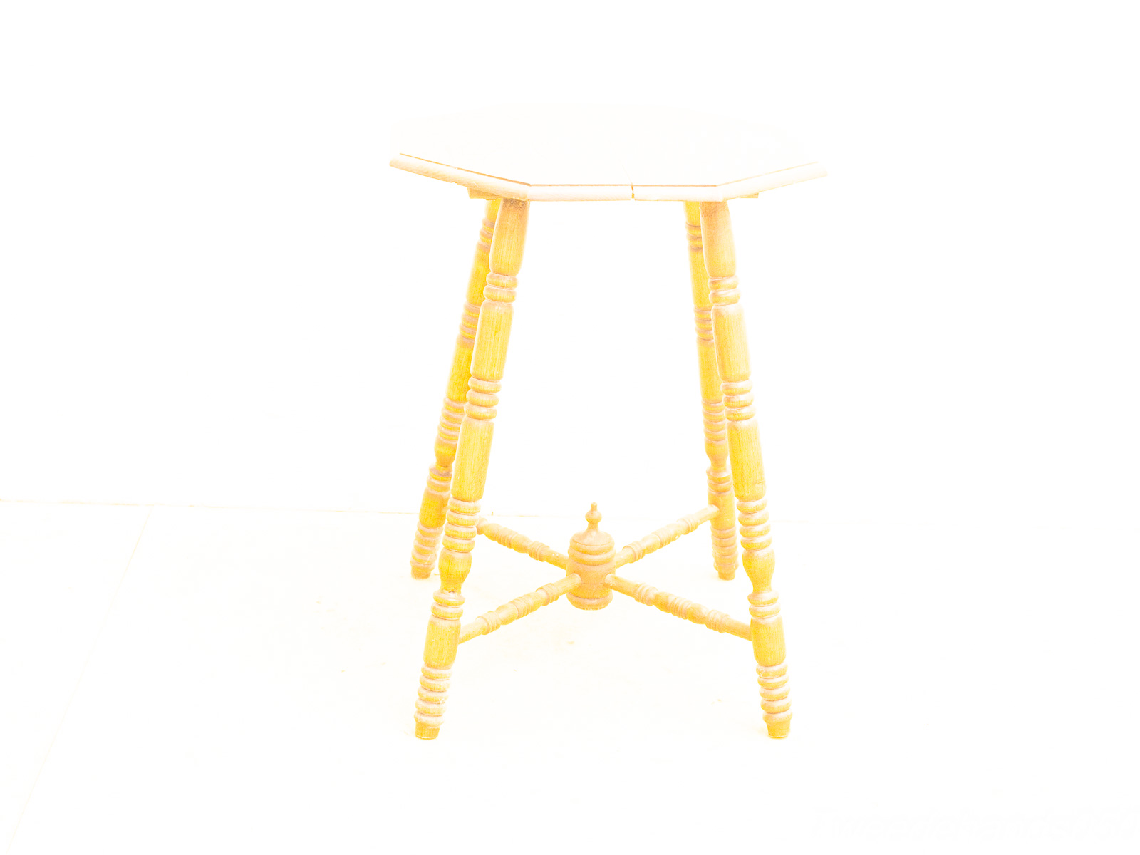 Elegant octagonal wooden stool with turned legs, perfect for rustic charm in any space.