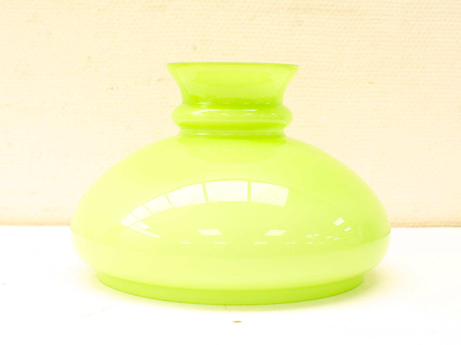 Glossy green vase with modern design, perfect for enhancing any interior decor.