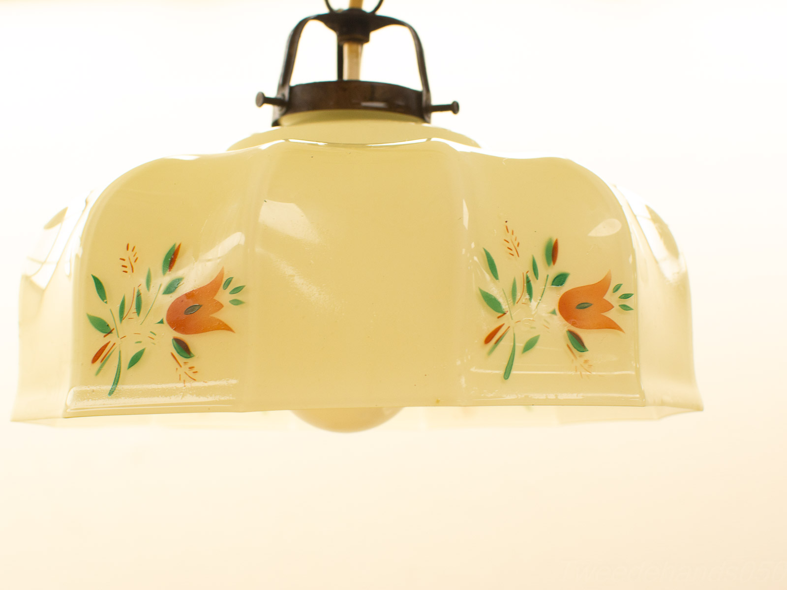 Vintage creamy yellow pendant light with vibrant floral motifs and antique metal fixture.