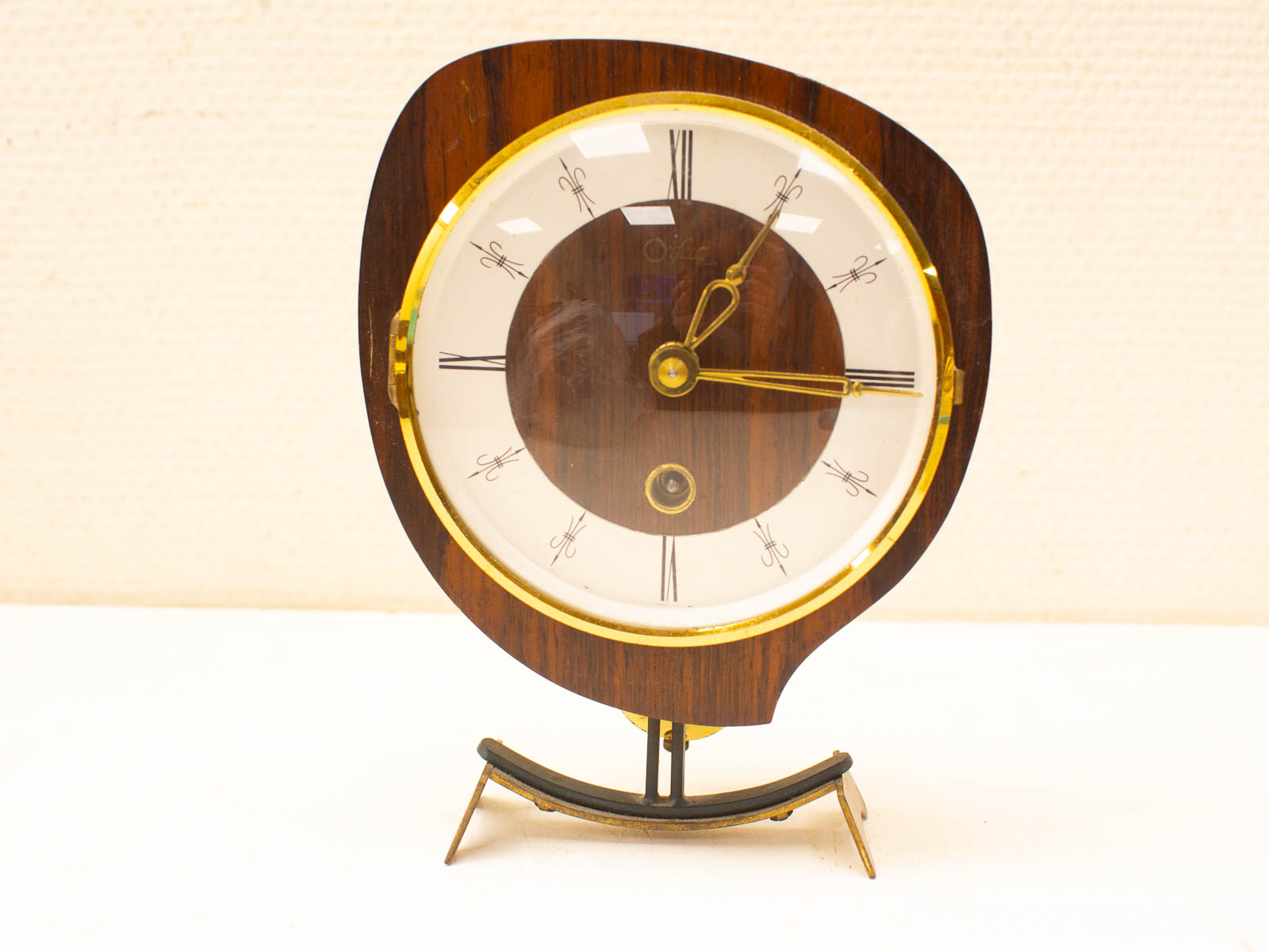 Elegant vintage wooden table clock with gold hands and a unique modernist design.