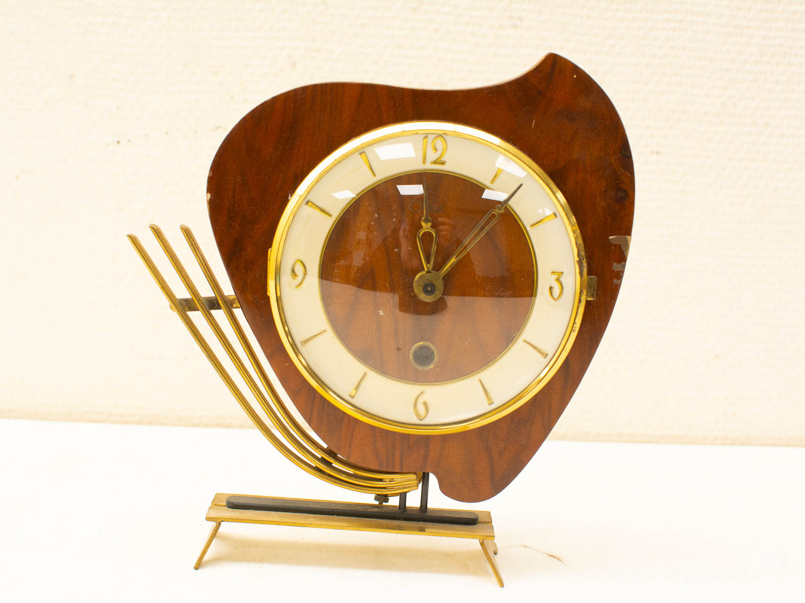 Elegant vintage clock with wooden casing, gold accents, and a stylish design for any decor.