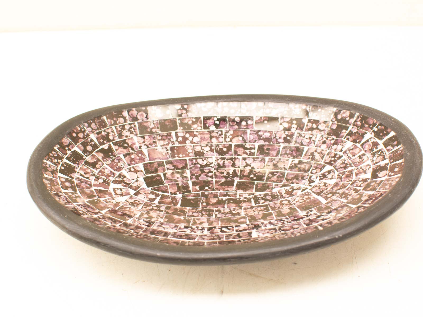 Elegant mosaic bowl in purple, pink, and black; perfect centerpiece for home decor.